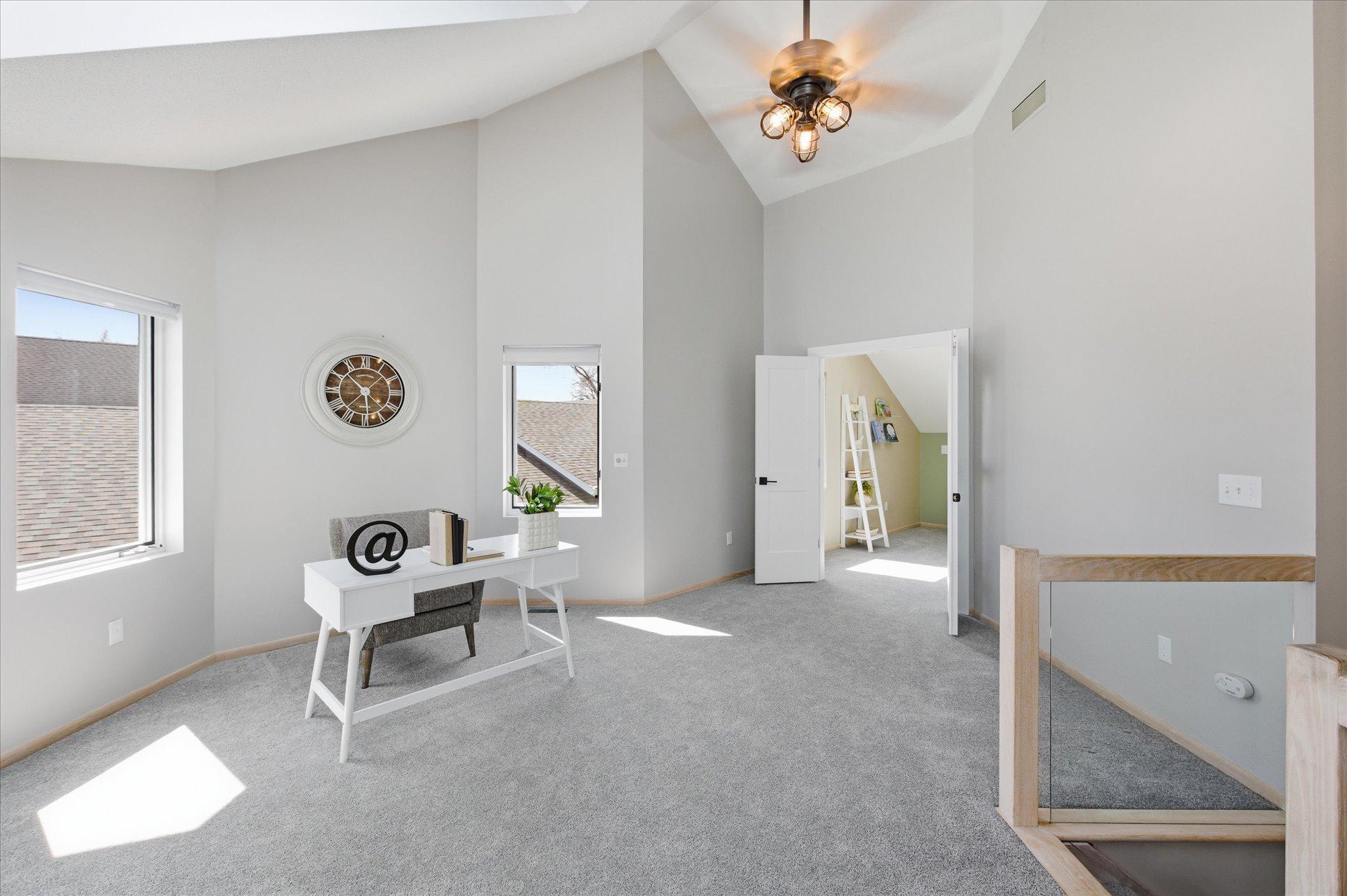 Upper-level loft offering flexible living space suitable for a home office, reading area, or family room.