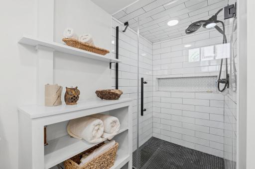 Large step in shower with glass door