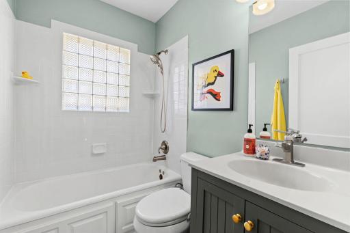 Updated main floor bath with glass block window