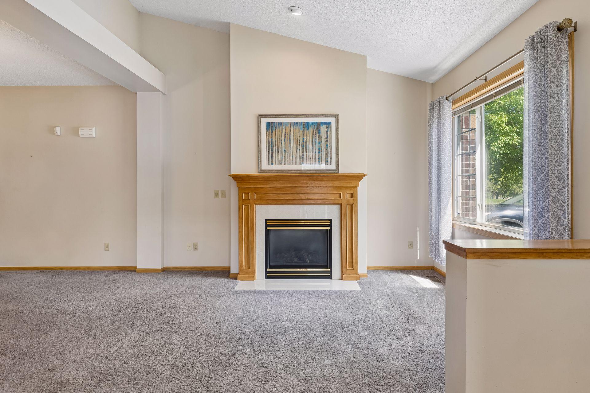 Enter the living room where a gas fireplace greets you.