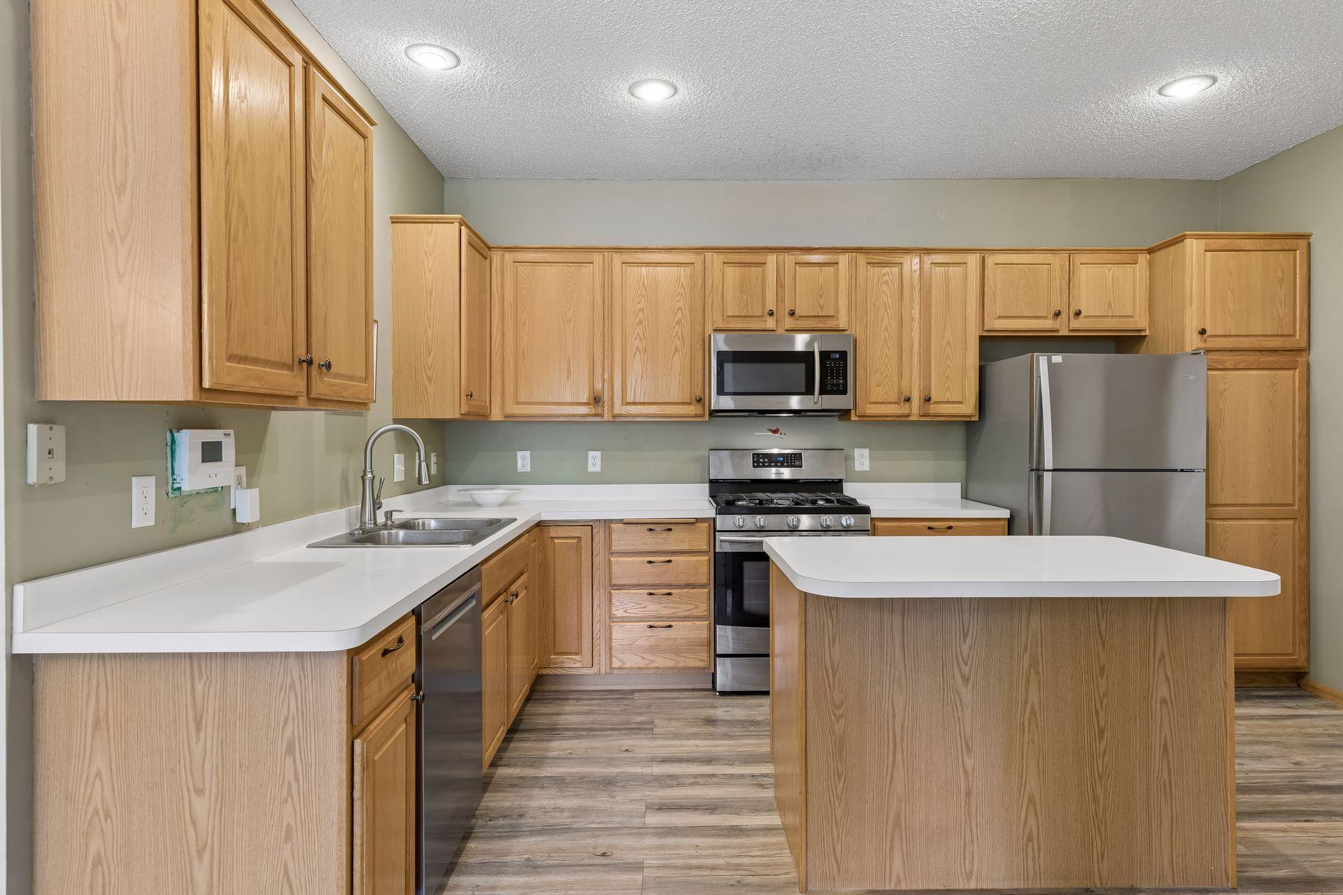 This kitchen is very functional with a center island and an abundance of cabinets.