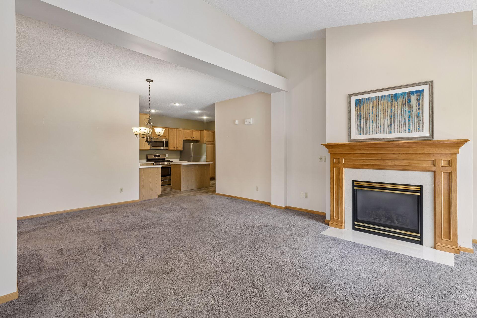 The dining area shares the living area creating versatility for furniture placement. A chandelier hangs above the intended dining area.