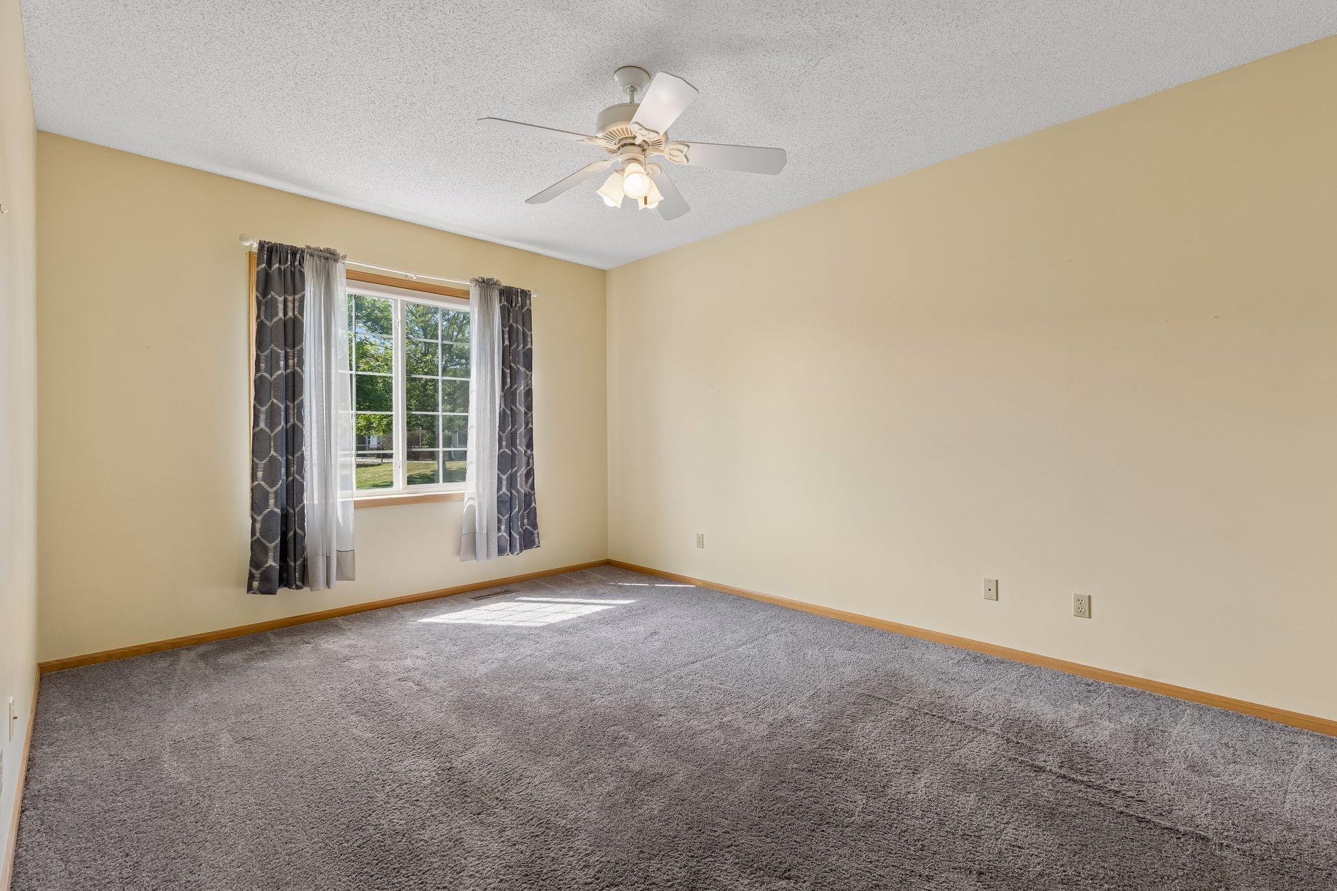 The primary bedroom is large and easily accommodates a king bed, dressers and other furniture pieces.