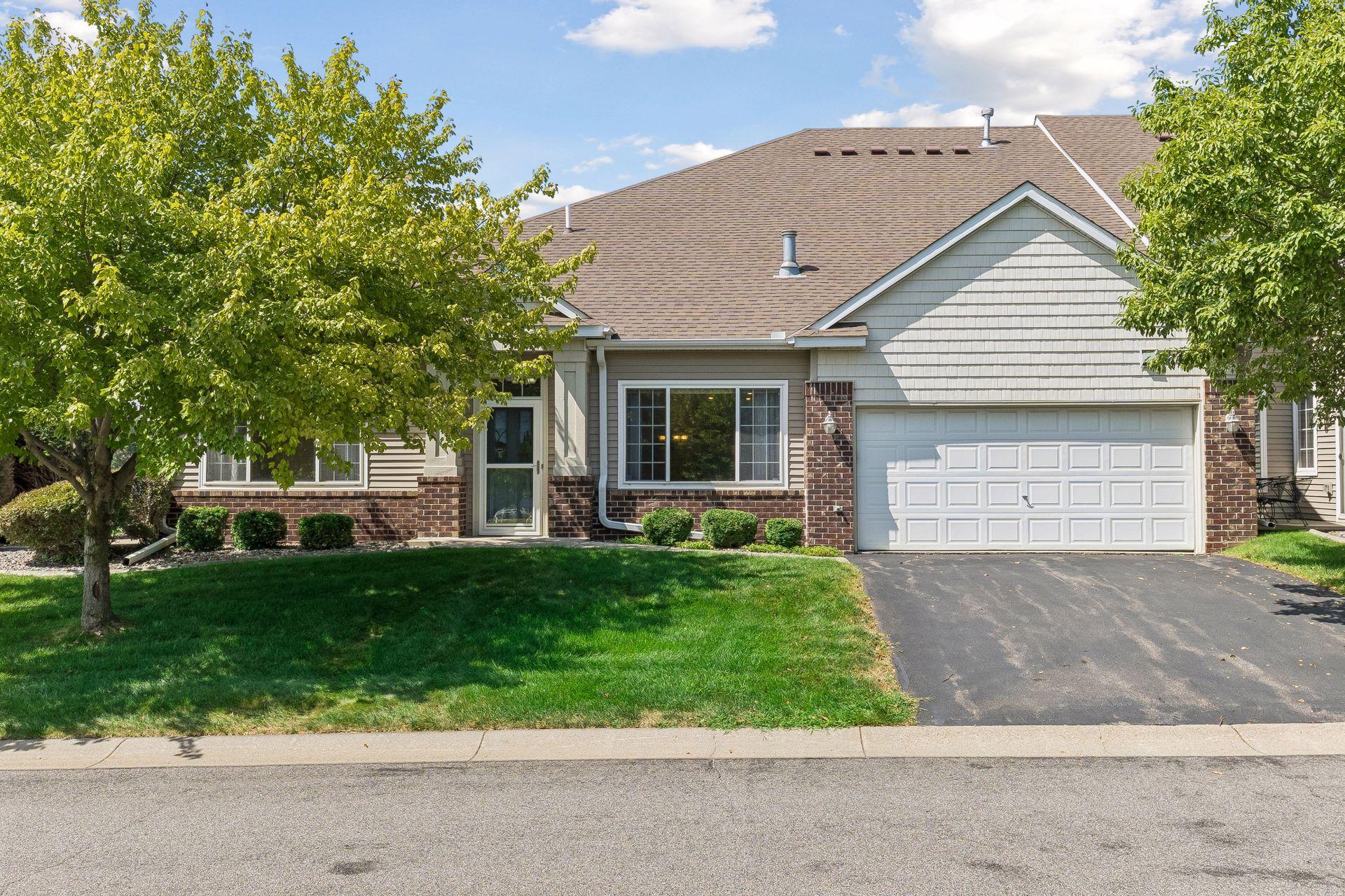 This pleasant EAST facing home is surrounded by trees and foilage and the elevated roof shows there are vaulted and high ceilings inside.