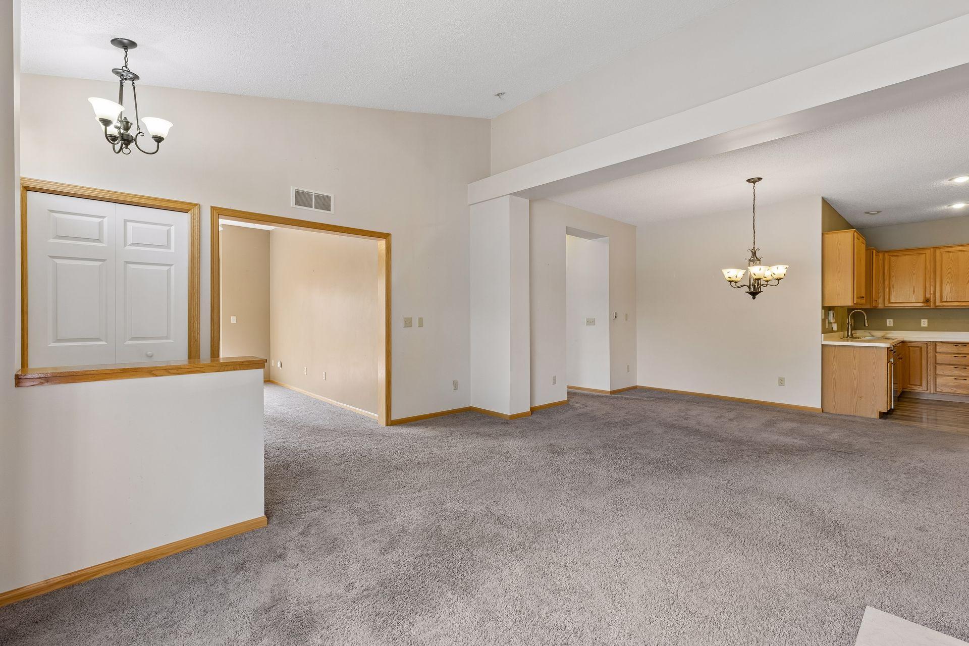 This picture shows the front entry closet and the light-filled sunroom next to it. The hallway to the bedrooms is the next opening.