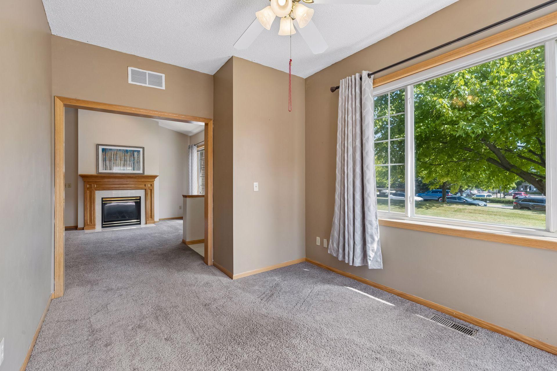 The sunroom has a huge picture window and the trees outside provide privacy.