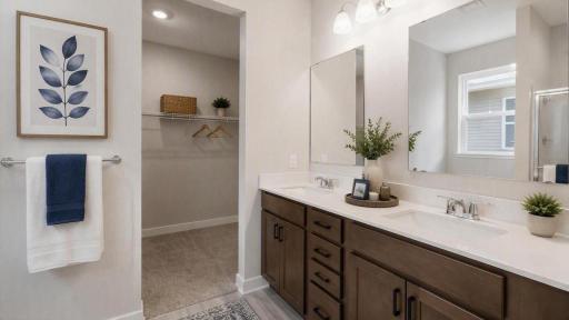 Dual vanity with quartz countertops in primary bath.
