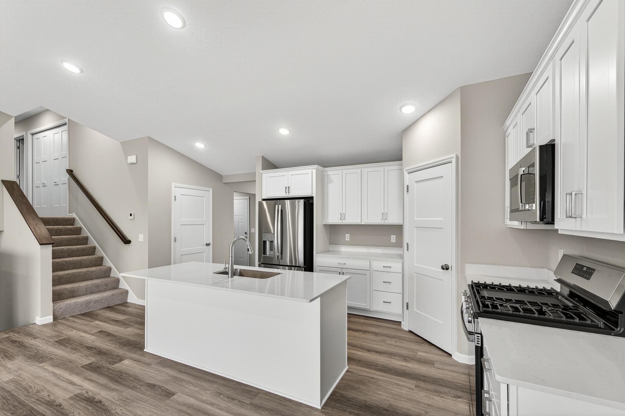 Photo is former Model. This home will not have the sink in the island. See Rendering of the kitchen in photos.