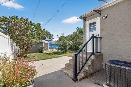 Rear stairs off of the kitchen bring you to the backyard
