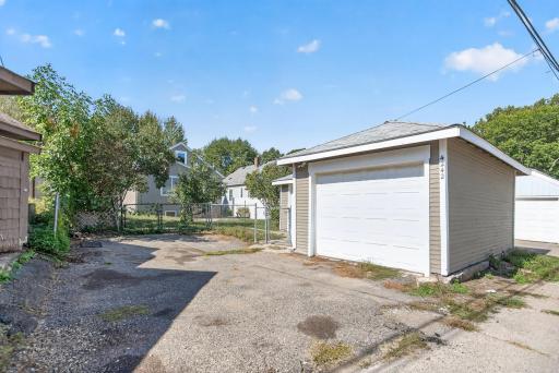 Standing in the alley you can see the parking pad as well as the garage