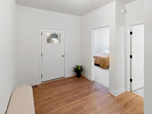 Welcoming foyer with warm LVP flooring and a bright, open feel. Photo shown is from a previously built home; selections and finishes may vary.