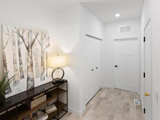 Functional mudroom conveniently located off the garage with additional storage nearby. Photo shown is from a previously built home; selections and finishes may vary.