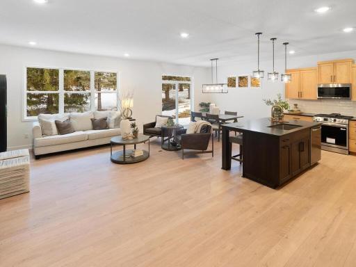 Open-concept design seamlessly connects the great room, kitchen and dining areas. Photo shown is from a previously built home; selections and finishes may vary.