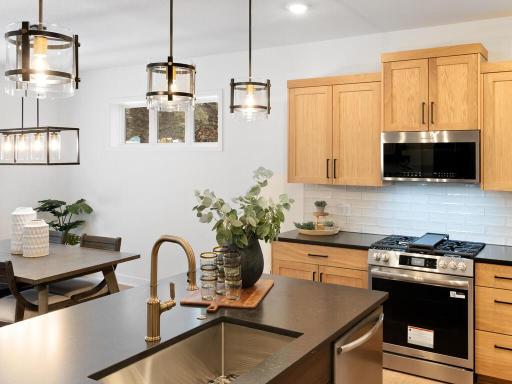 Generous center island provides additional prep space, storage and casual seating. Photo shown is from a previously built home; selections and finishes may vary.