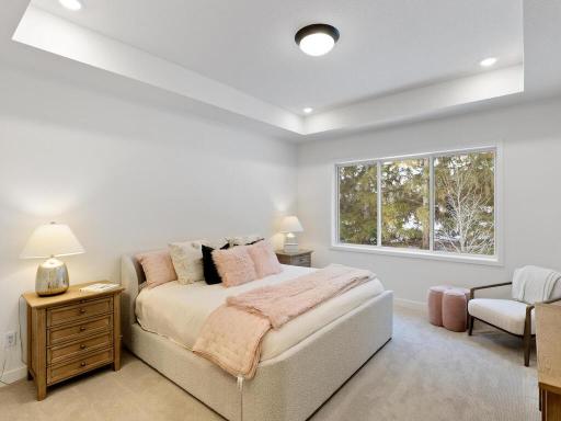 Spacious primary bedroom features a beautiful box-vault ceiling and oversized window for plenty of natural light. Photo shown is from a previously built home; selections and finishes may vary.