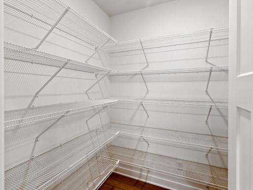 Generous walk-in pantry offers abundant shelving and storage. Photo shown is from a previously built home; selections and finishes may vary.