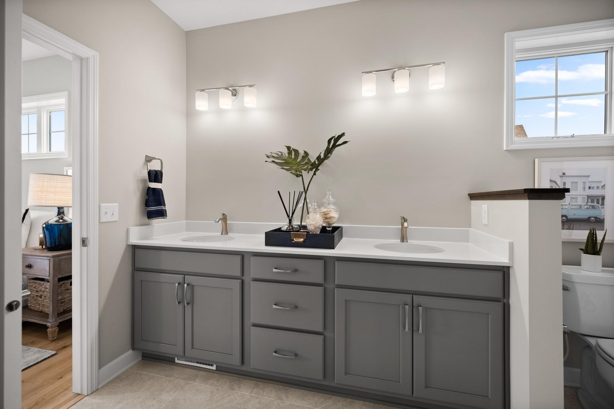 The owner's bath has everything you are looking for with a large two sink vanity, walk in shower and look at all the storage space! (model photo)