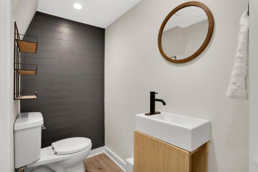 Lower Level 1/2 bath. (behind the dark wall is a space with a drain for a shower, lighting, fan and electrical)