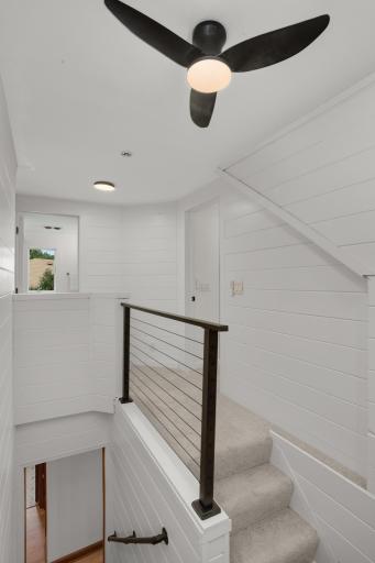 New carpet, lighting, railings and shiplap walls going upstairs