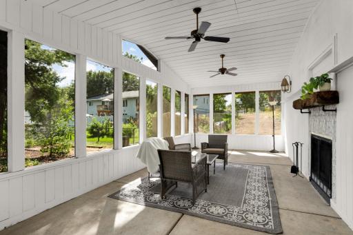 Amazing outdoor screen porch with a wood fireplace that has been cleaned and ready to use.