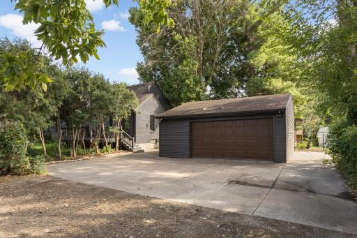 Oversized 2 car garage with a garage door opener. Side cement pad