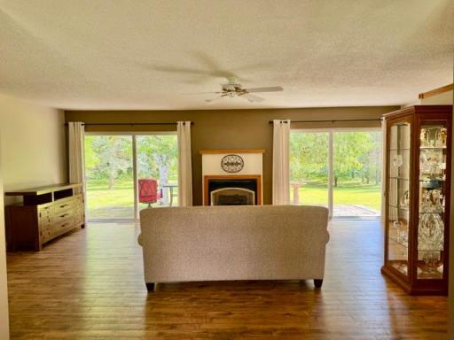 Gas fireplace flanked by 2 sets of patio doors