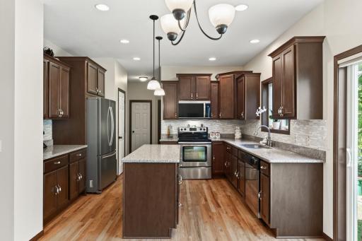 Kitchen: Beautiful kitchen featuring a spacious center island with granite countertops and ample cabinetry for storage.