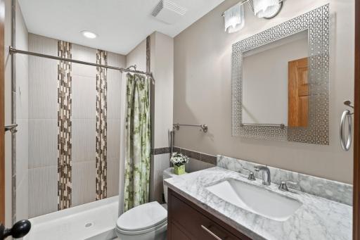 Basement Bath: Beautifully remodeled ¾ bathroom with updated finishes.
