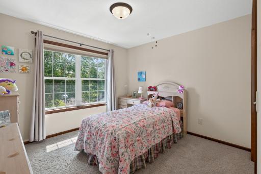 Bedroom 2: Spacious upper-level bedroom with generous closet space.