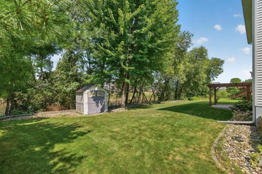 Backyard: Oversized backyard overlooking the pond, offering peaceful views and plenty of outdoor space.