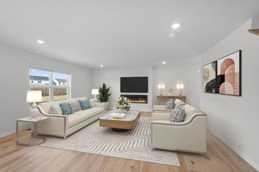 Spacious living room w/low profile fireplace! Blinds included on all functioning windows (excluding patio door). Photos are for representational purposes. Styles, colors and selections may vary.