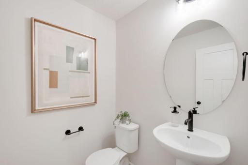 Charming main floor powder room. Photos are for representational purposes. Styles, colors and selections may vary.