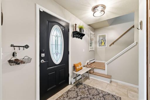 A bright entry and central staircase introduce the home’s practical two-story layout.