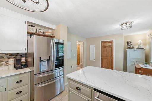 Quartz countertops, professionally finished cabinetry and updated appliances combine style with everyday function.