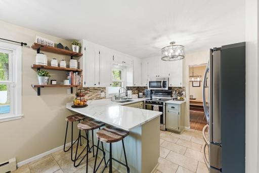 Casual counter seating creates an easy place for morning coffee, quick meals or conversation while cooking.
