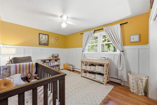 An additional upper-level bedroom provides flexibility for guests, an office or creative space.