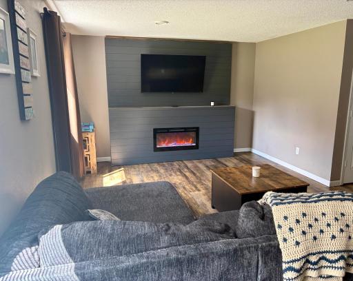 Lower-level family room with electric fireplace
