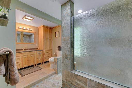 Amazing new walk in shower. Pine cabinetry in bath.