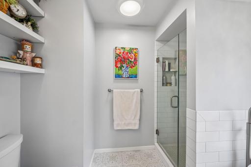 Primary bathroom titled walk in shower