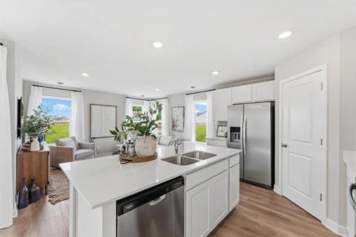 The kitchen is open to the family room. *Photo of similar model home. Color and options may differ.