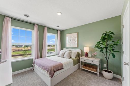 Secondary bedroom on the upper level. *Photo of similar model home. Color and options may differ.