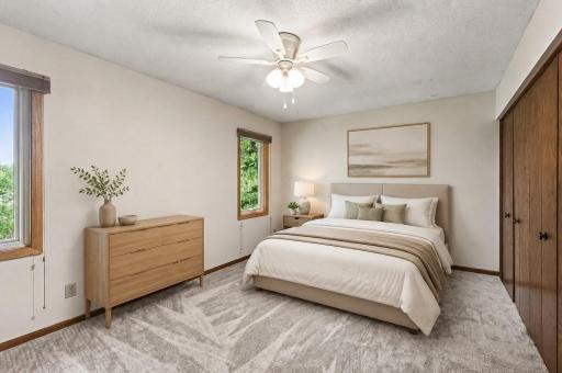Virtually staged primary bedroom with double closets and private 3/4 bathroom.