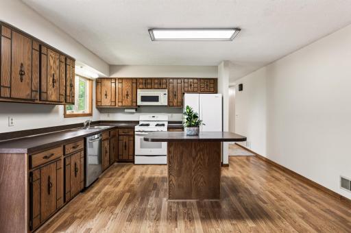 Spacious kitchen with large center island and ample cabinet space.
