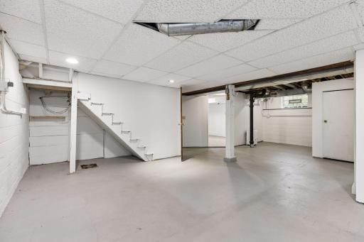 The basement has a large partially finished family room - just add flooring and some additional drywall!