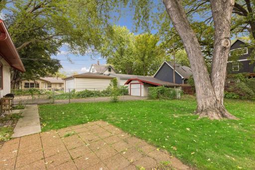 Alternate view of the backyard looking at the driveway and garage.