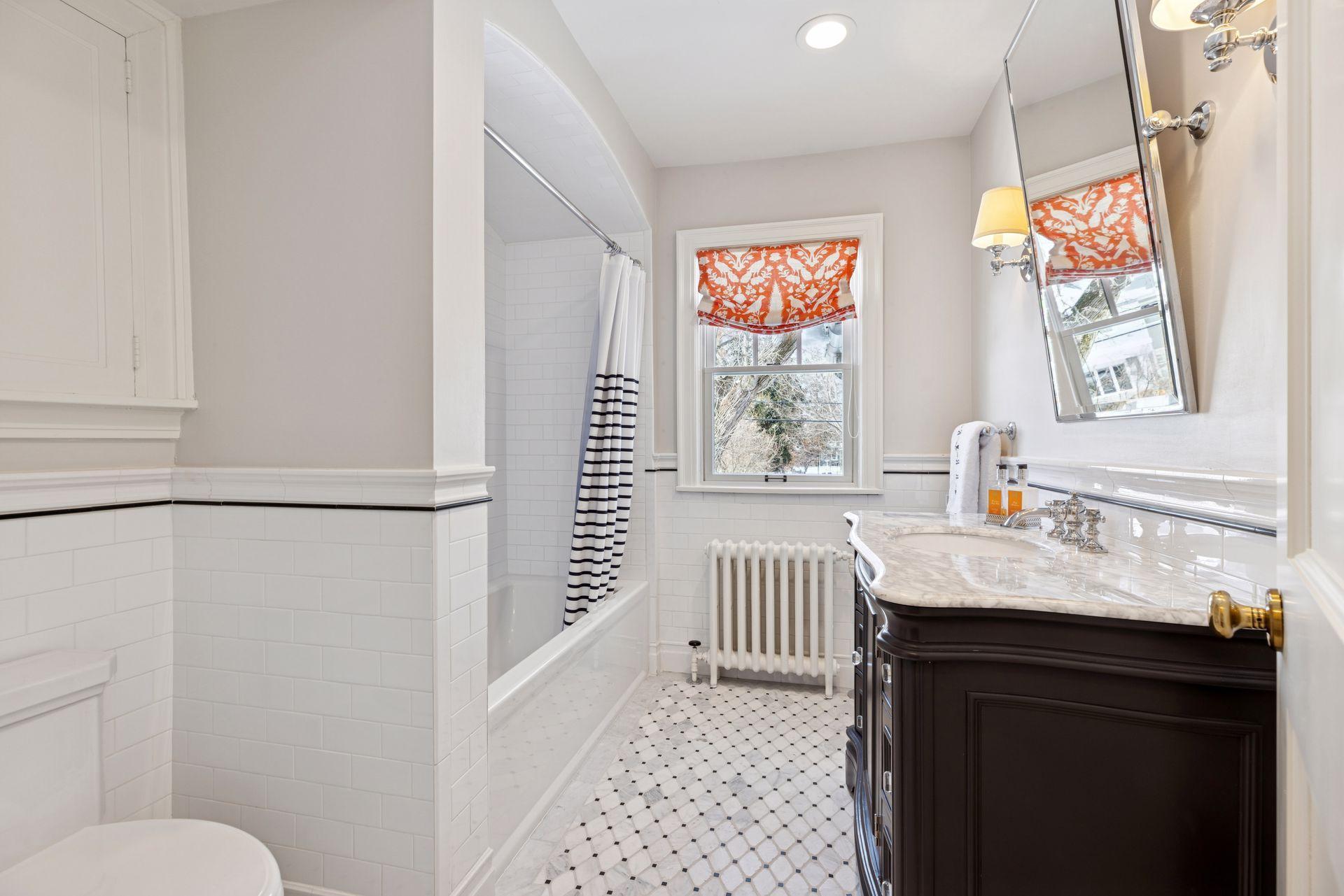A well-appointed full bath serving the second level and 3rd and 4th bedrooms..