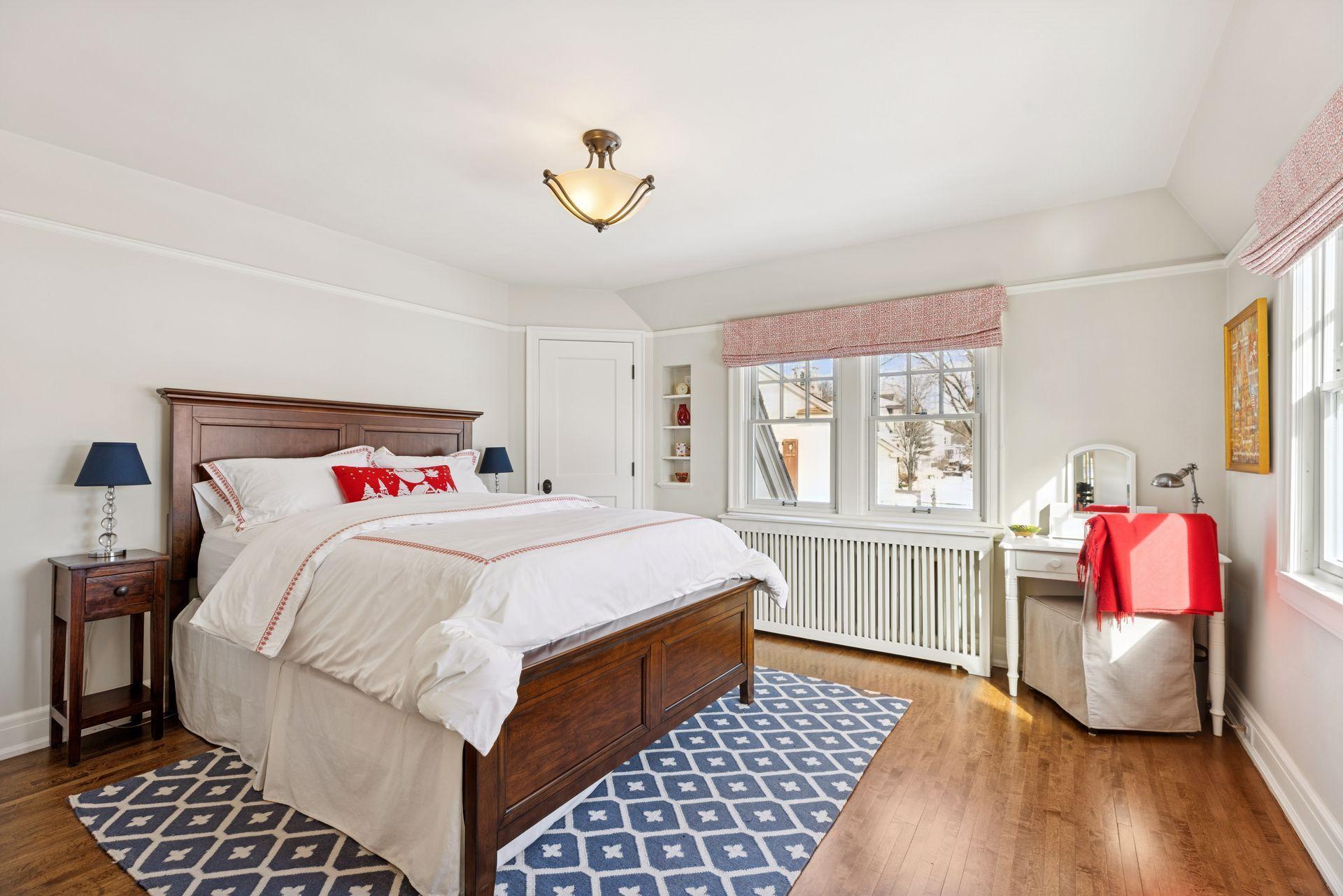 Sunlight fills the space, highlighting a versatile bedroom that easily doubles as a quiet home office