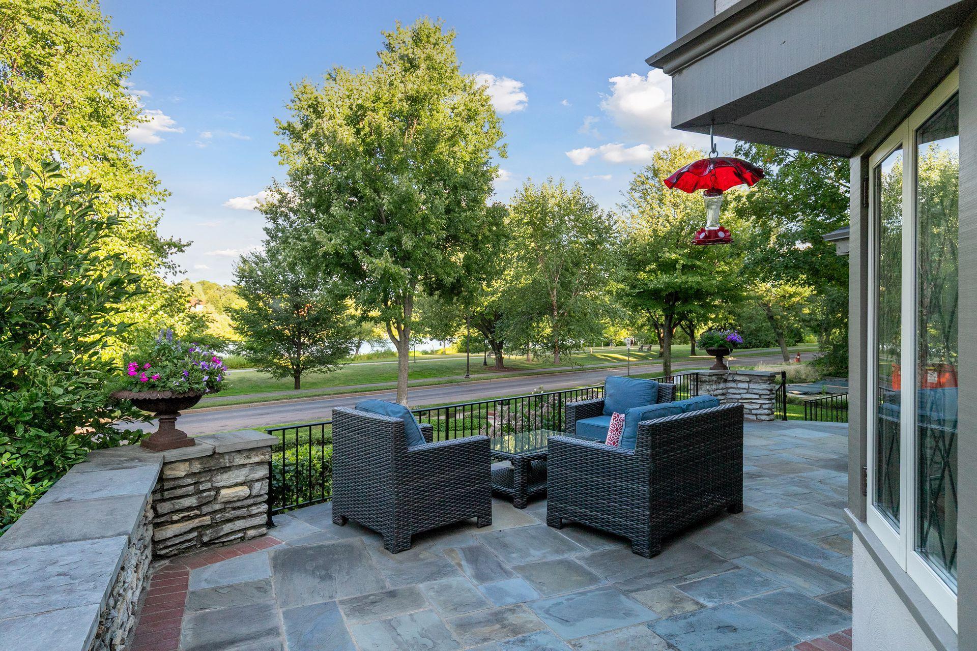 The expansive front patio feels like an outdoor living room, with a front-row seat to life along Lake of the Isles.