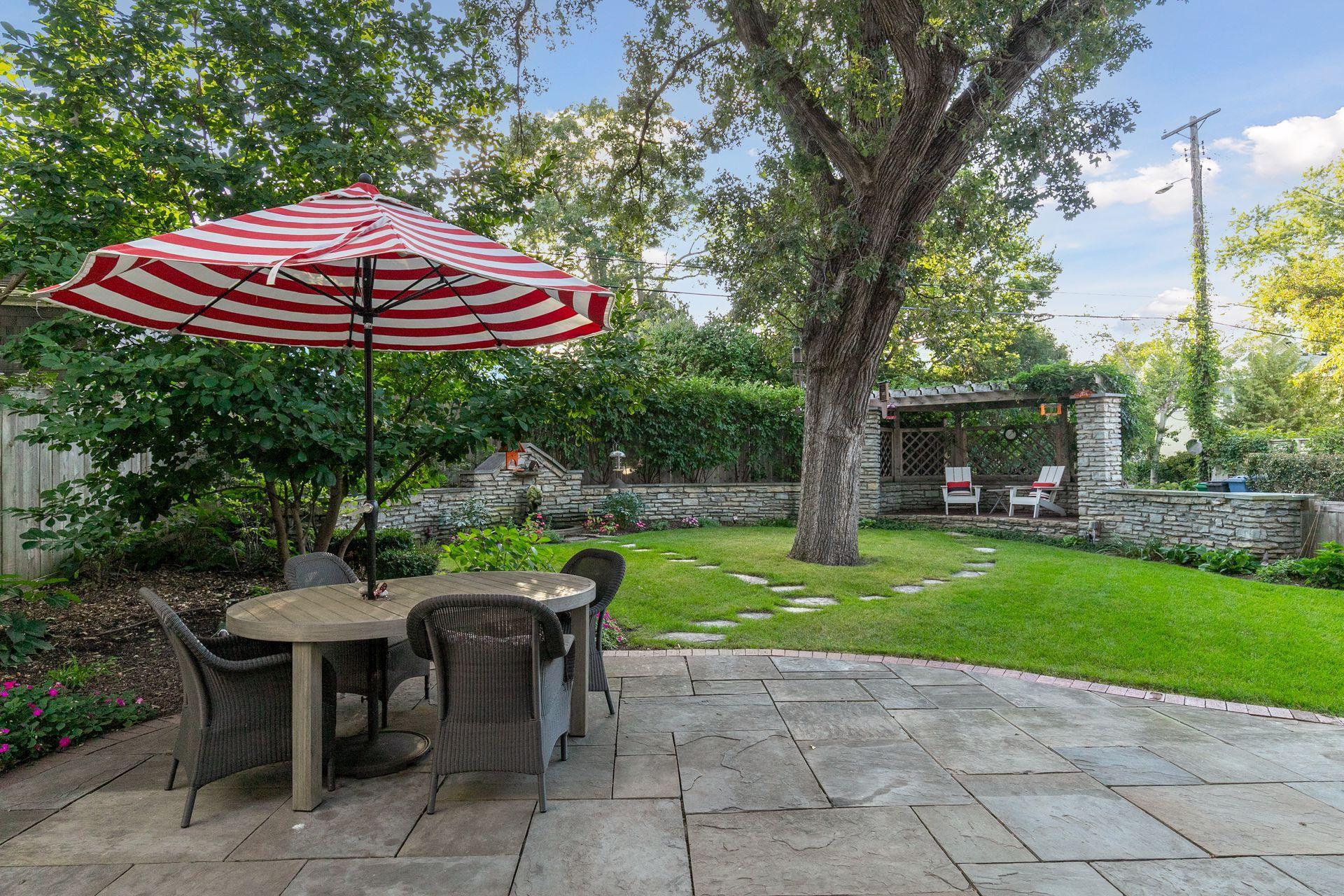 A gorgeous canopy of mature trees anchors the backyard and provides shade throughout the summer.