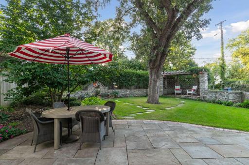 A gorgeous canopy of mature trees anchors the backyard and provides shade throughout the summer.